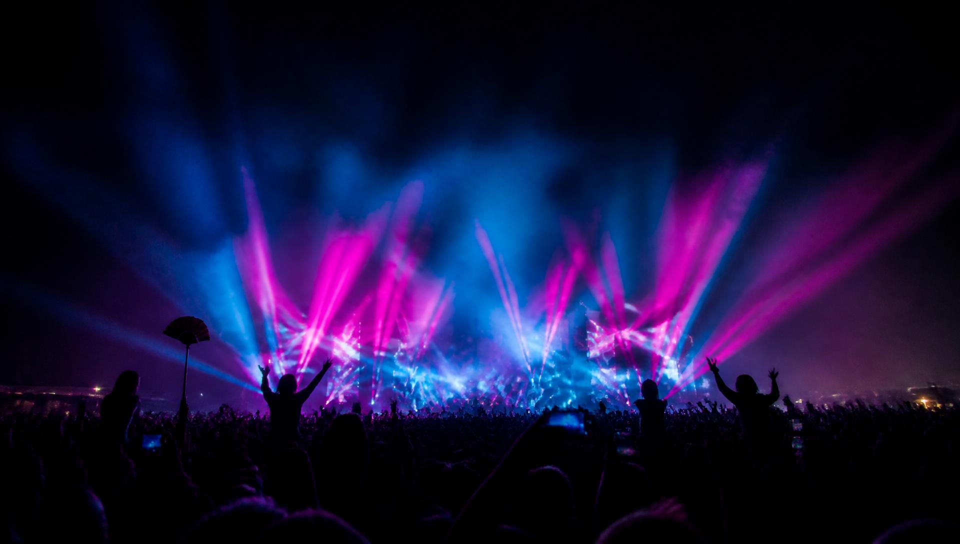 Night festival crowd with magenta and cyan stage lights